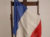 a flag that is on a chair in front of a wall