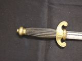 a sword that is laying on a black surface