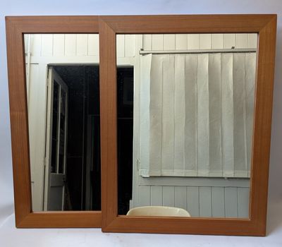 a mirror that is sitting on a table in front of a window