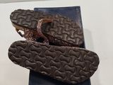 a pair of shoes that are on a blue box