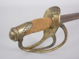 a close up of a sword with a wooden handle
