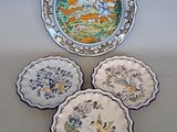three plates with different designs on them sitting on a table