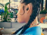 a woman with braids on her head looking at her cell phone