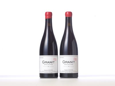 two bottles of red wine sitting next to each other on a table