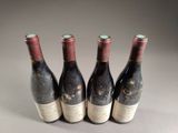 three bottles of wine are lined up in a row on a table