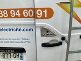 a white van with an electric sign on the side of it