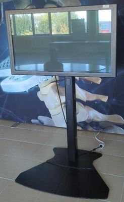 a flat screen tv sitting on a stand in a room