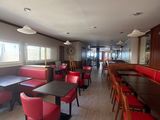 a long table with red chairs in the middle of the room