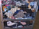 a large metal cage filled with lots of stuffed animals