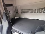 a bed in the back of a van with a seat up
