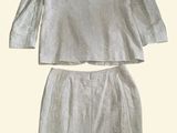 the two piece skirt suit is made of linen and has a long sleeves