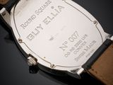 an image of a close up of a watch on a black surface