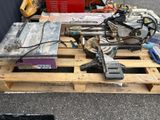 a pile of tools sitting on a pallet in the street