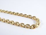 a close up of a gold chain on a white surface