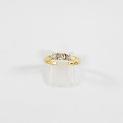 a yellow gold ring with three diamonds on top of it