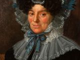 portrait of a woman in a black dress and a blue hat