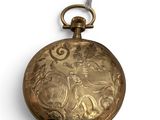 a gold colored pocket watch with a chain on it