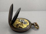 a pocket watch that is open on the table