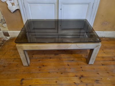 a glass table with a glass top on a wooden floor