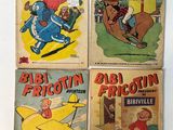 four vintage comic books are on display on a white surface