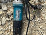 a drill on the ground with a cord attached to it