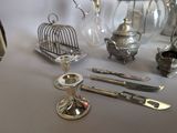 a table with silver objects on it and a birdcage