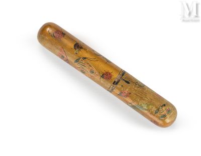 a wooden bat with a design on it on a white surface
