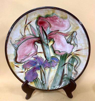 a plate with a painting of flowers on it
