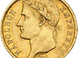 a close up of a gold coin with a woman ' s head on it