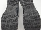 the soles of a pair of black shoes on a white surface
