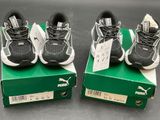 two pairs of shoes are on top of a box on a table
