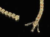a close up of a necklace and bracelet on a black surface