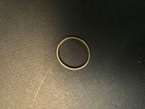 a close up of a gold ring on a black surface