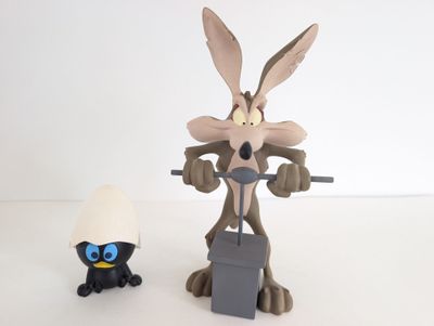 a figurine of a rabbit and an egg sitting next to each other