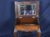 an old wooden table with a mirror on top of it