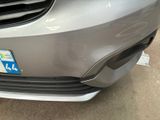 a close up of the front bumper of a silver car