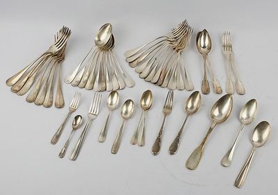 a lot of silver spoons and spoons on the table