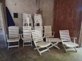 a lot of lawn chairs and umbrellas in a room