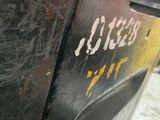 a close up of a metal door with graffiti on it