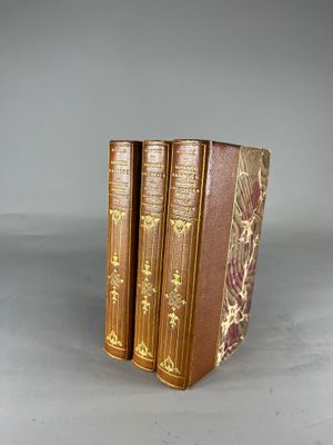 three books sitting on top of each other on top of a table