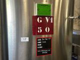 a stainless steel refrigerator with a sign on the door