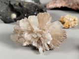 a cluster of crystals on a table next to other rocks