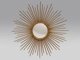 un miroir doré à rayons, accroché au mur