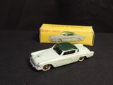 a toy car that is sitting next to a box of toys