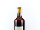 an image of a bottle of wine sitting on a white surface