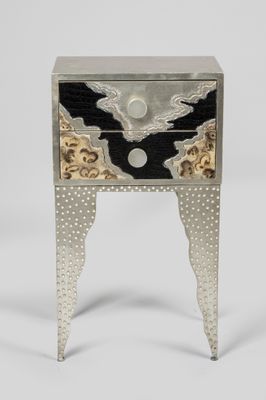 an image of a silver and black side table with a bird on it