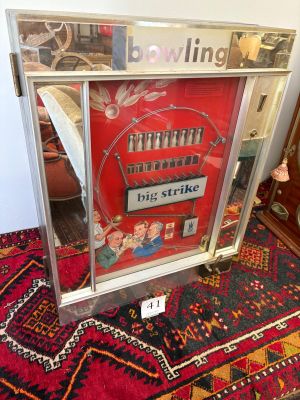 a picture of a picture of a bowling game in a glass case