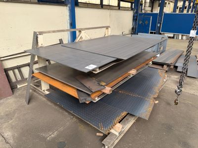 some steel plates are stacked on top of each other in a warehouse