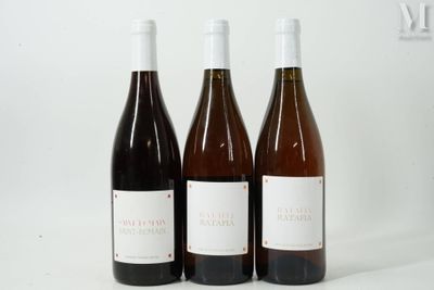 three bottles of wine sitting next to each other on a white surface