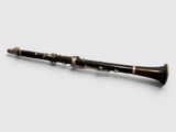 a close up of a clarinet on a white surface